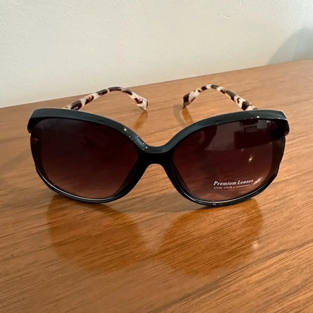 New Fashion Sunglasses Large Frames, Black frames with tortoise shell stems.